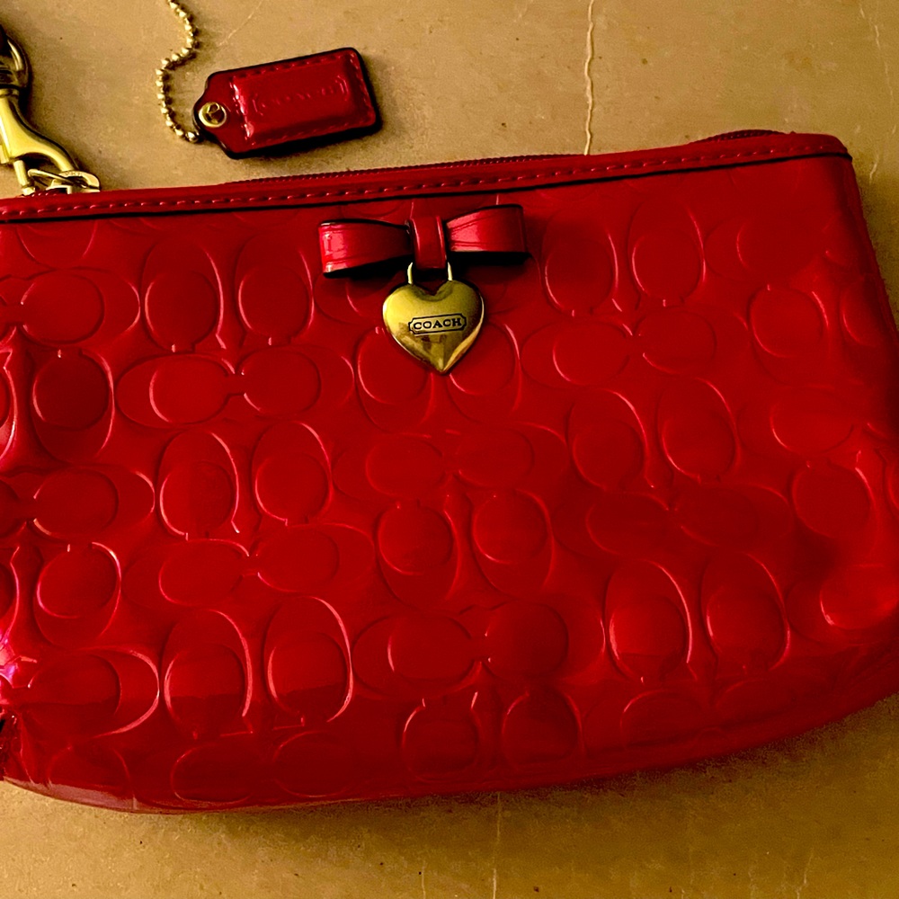 Coach red wristlet purse embossed patent leather with the Coach “C” trademark